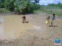 Crianças pescando na lama